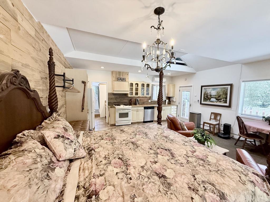 22292 Crestline Road Palomar Mountain, CA 92060 - Photo 30 of 38 a bedroom with a bed chandelier and a window