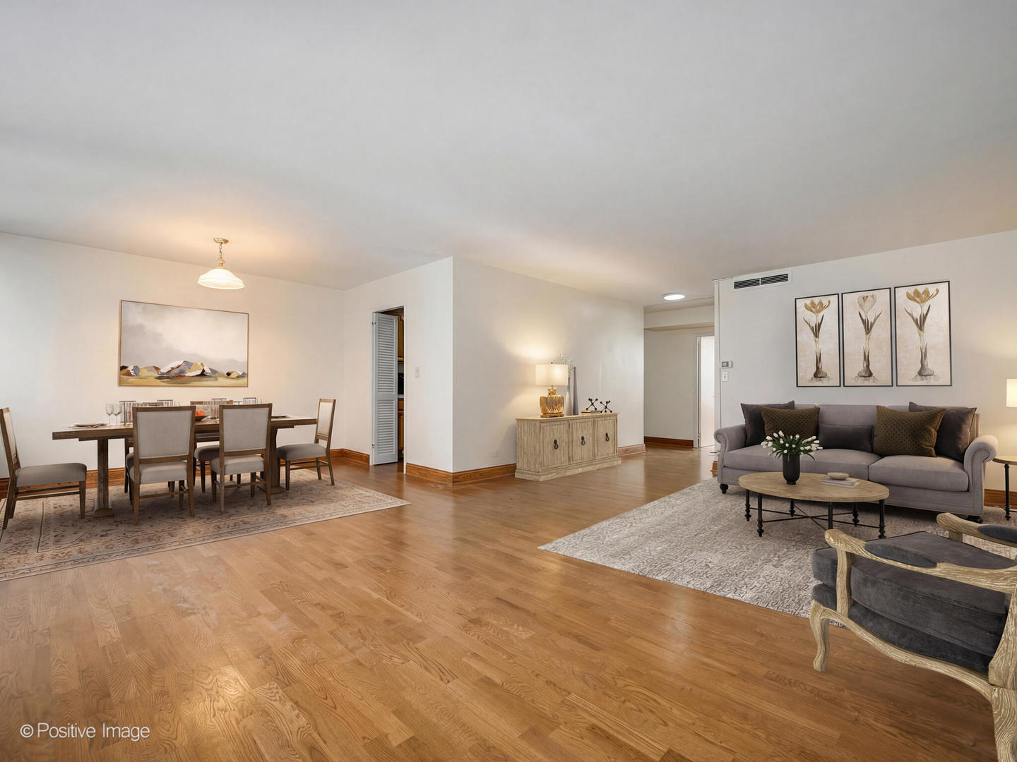 6301 North Sheridan Road, Unit 14O Chicago, IL 60660 - Photo 2 of 22 a living room with furniture and a dining table with wooden floor