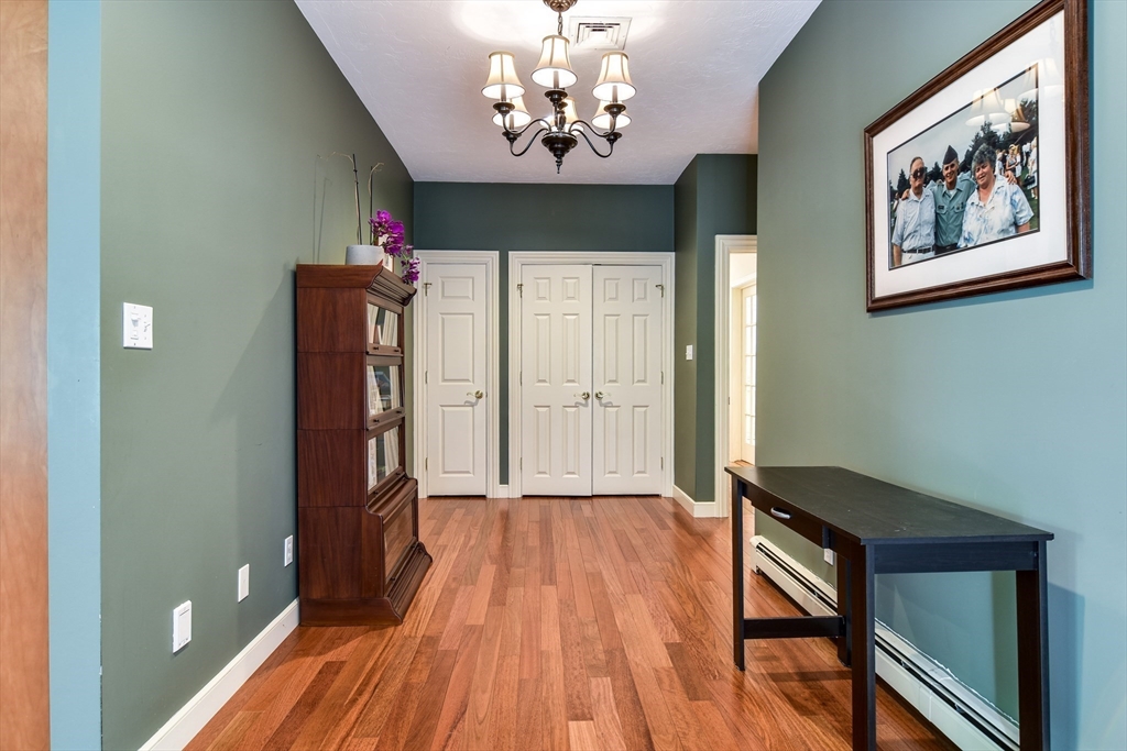 60 Lantern Lane Needham, MA 02492 - Photo 12 of 36 a view of a room with wooden floor closet and a chandelier