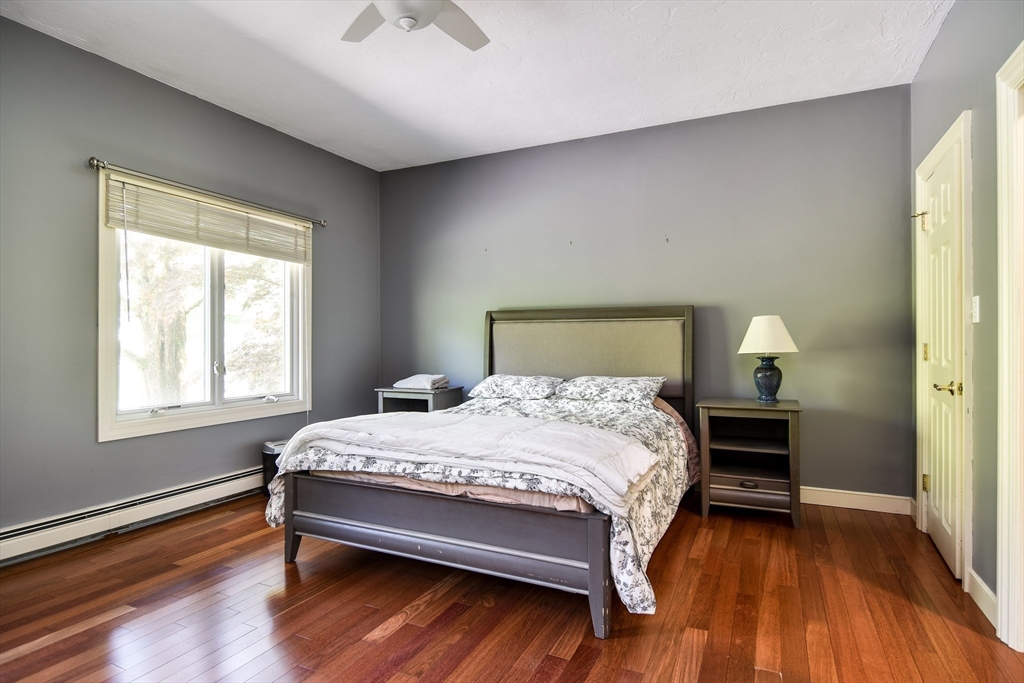 60 Lantern Lane Needham, MA 02492 - Photo 15 of 36 a bedroom with a bed and wooden floor