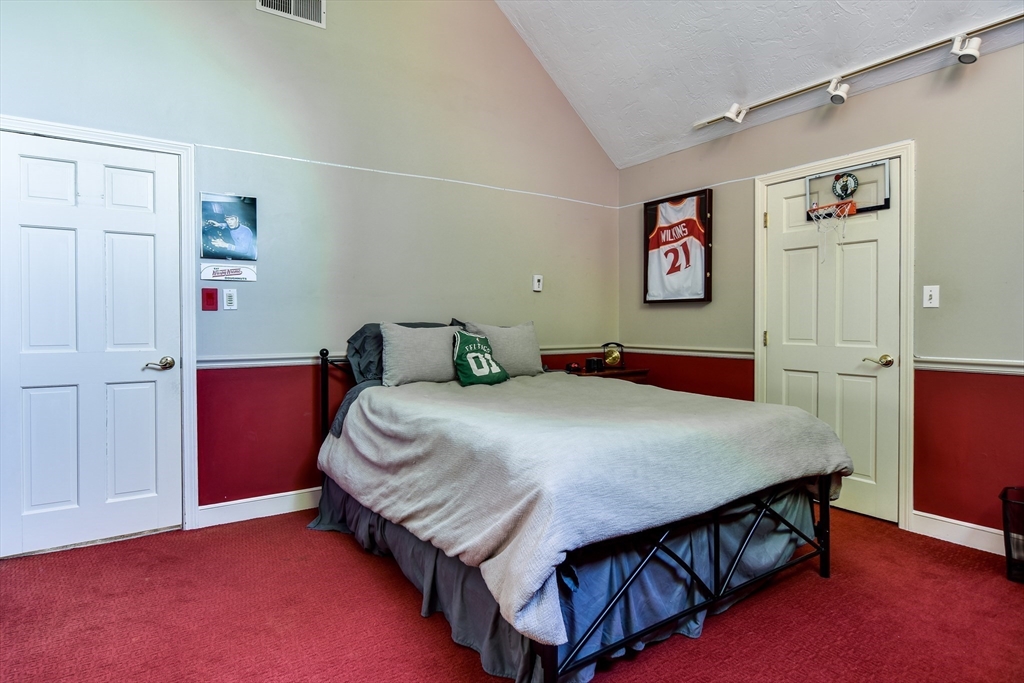 60 Lantern Lane Needham, MA 02492 - Photo 19 of 36 a bedroom with a bed and wooden floor
