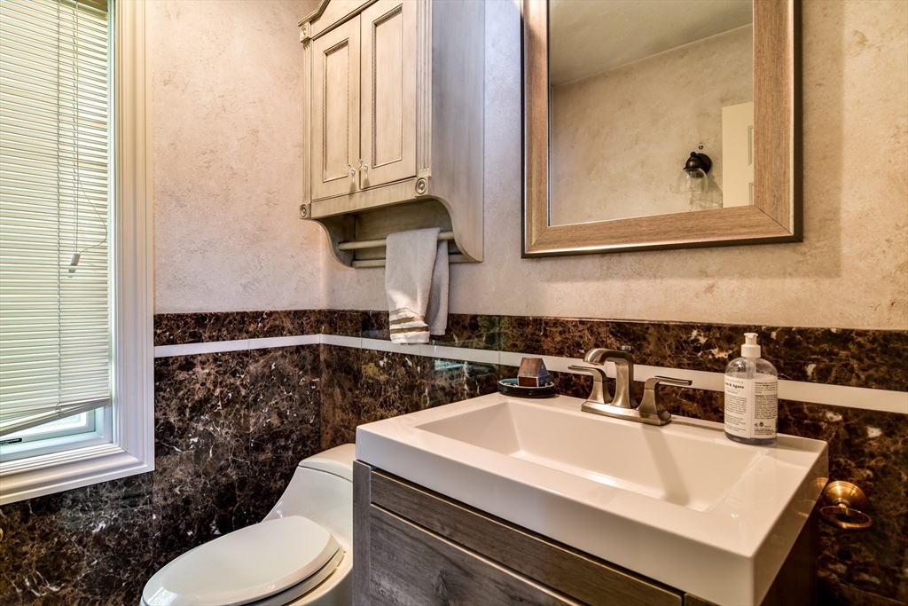 60 Lantern Lane Needham, MA 02492 - Photo 20 of 36 a bathroom with a sink a toilet and mirror