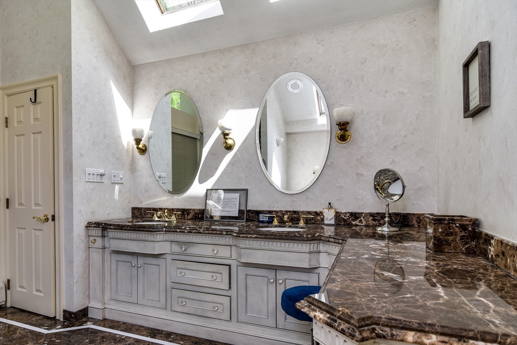 60 Lantern Lane Needham, MA 02492 - Photo 22 of 36 a bathroom with a double vanity sink and a mirror
