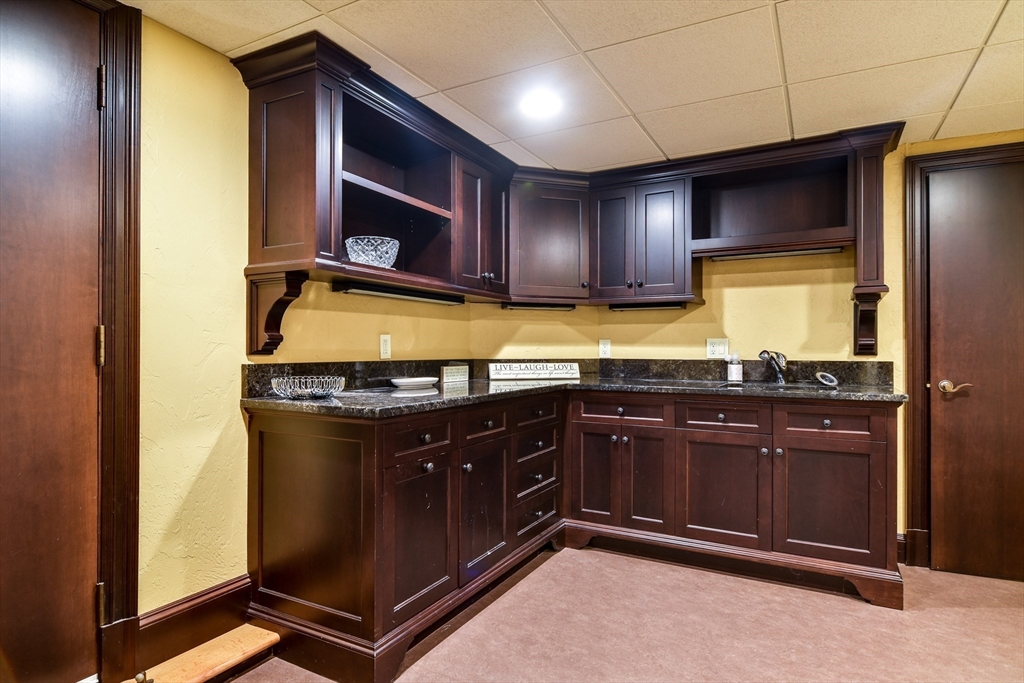 60 Lantern Lane Needham, MA 02492 - Photo 28 of 36 a kitchen with stainless steel appliances granite countertop a stove and a microwave