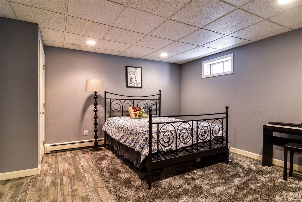 60 Lantern Lane Needham, MA 02492 - Photo 29 of 36 a bedroom with a bed and a table in it