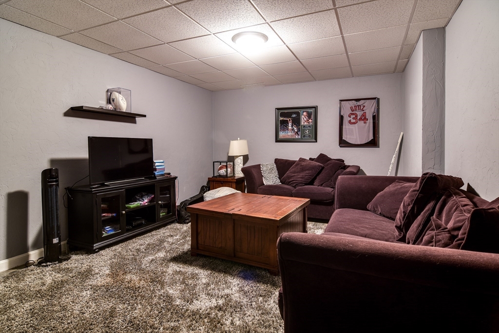 60 Lantern Lane Needham, MA 02492 - Photo 30 of 36 a living room with furniture and a flat screen tv