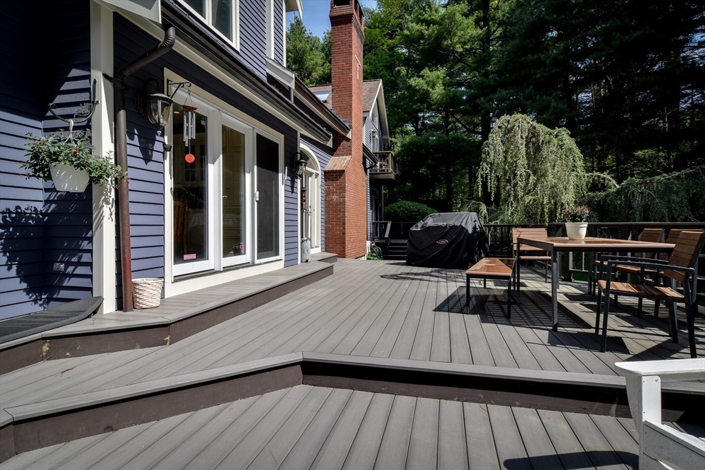 60 Lantern Lane Needham, MA 02492 - Photo 32 of 36 a view of deck with table and chairs a barbeque with wooden floor and fence