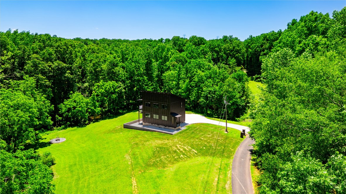 159 Cherokee Trail Easley, SC 29640 - Photo 36 of 38 A modern, angular residence nestled amidst a vibrant green landscape.