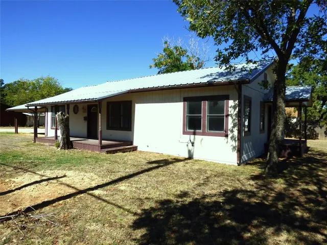 a front view of a house with a yard and porch