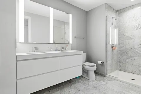 a bathroom with a sink toilet and shower
