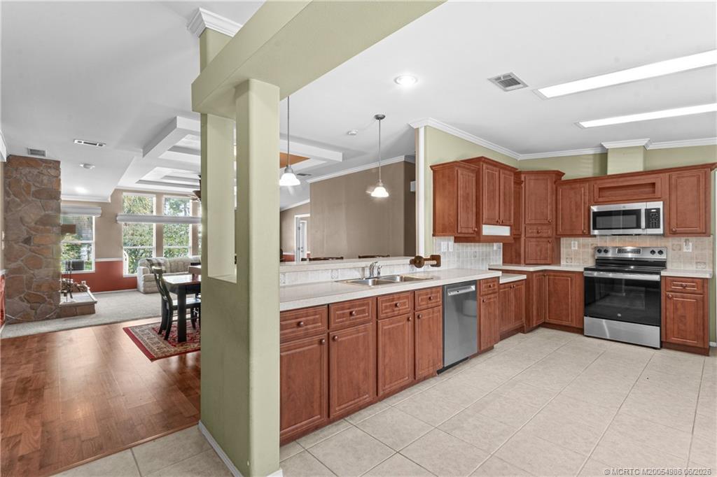 4237 4th Court Lantana, FL 33462 - Photo 7 of 40 a large kitchen with a large counter top stainless steel appliances and cabinets