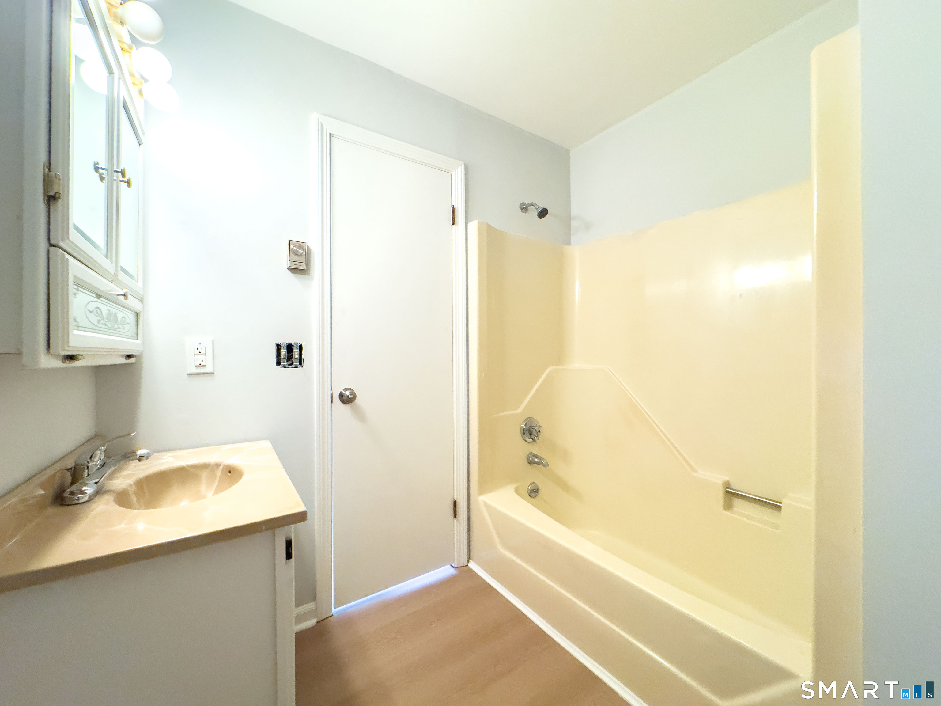 80 Olive Street Naugatuck, CT 06770 - Photo 11 of 28 a bathroom with a tub sink vanity and a mirror