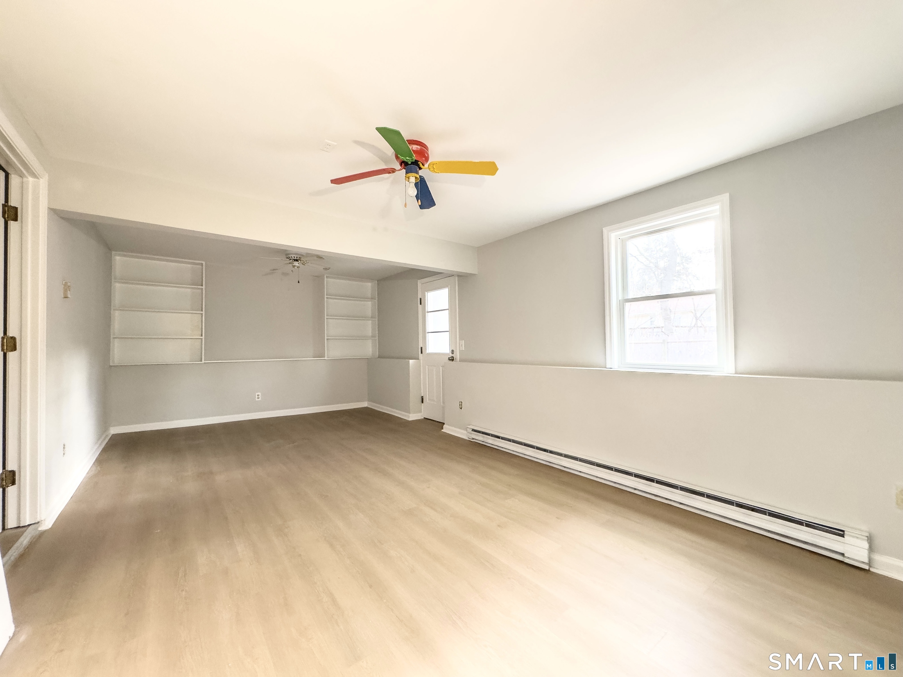 80 Olive Street Naugatuck, CT 06770 - Photo 25 of 28 an empty room with windows and chandelier fan