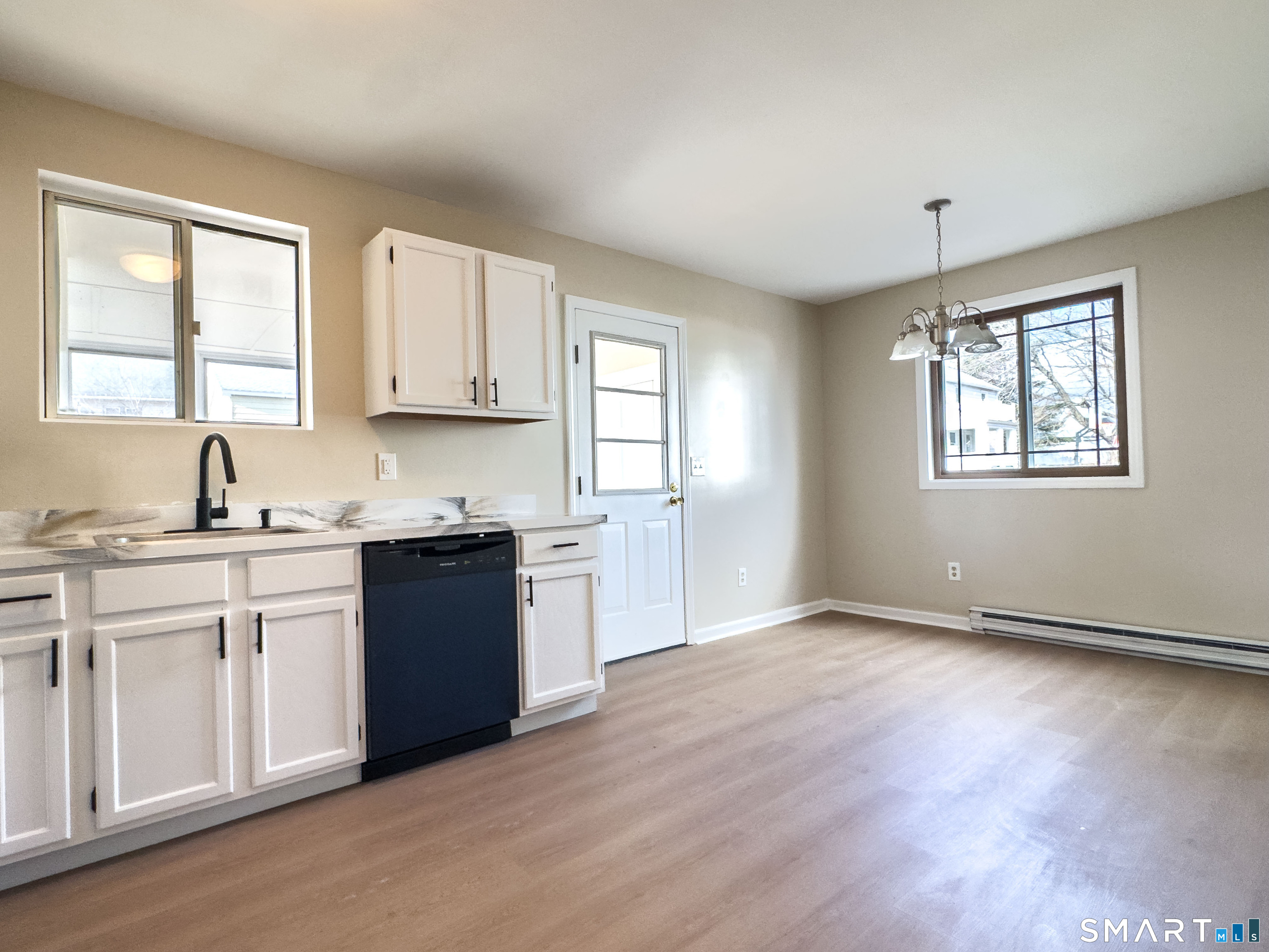 80 Olive Street Naugatuck, CT 06770 - Photo 8 of 28 a kitchen with granite countertop wooden floors and white appliances
