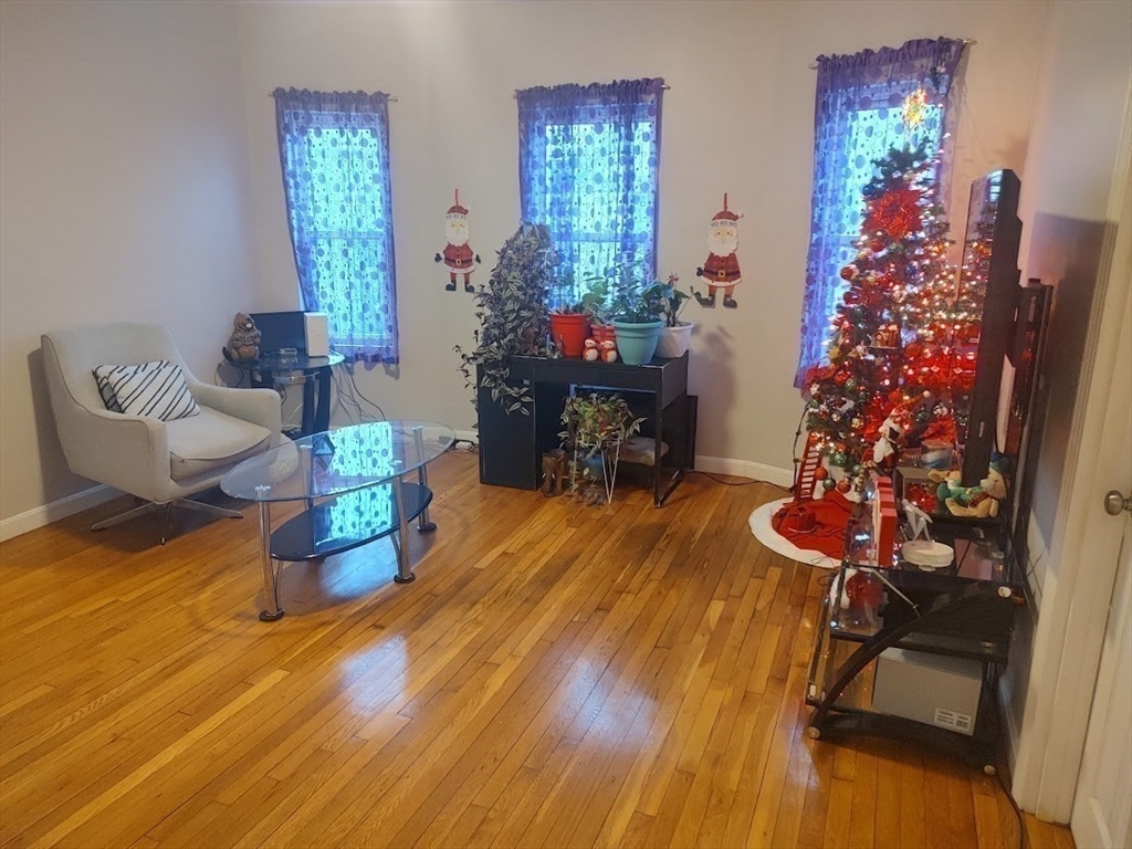 378 Ferry Street Everett, MA 02149 - Photo 13 of 26 a living room with furniture and flowers