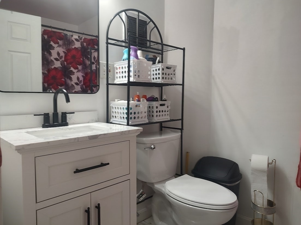 378 Ferry Street Everett, MA 02149 - Photo 16 of 26 a bathroom with a toilet sink and mirror