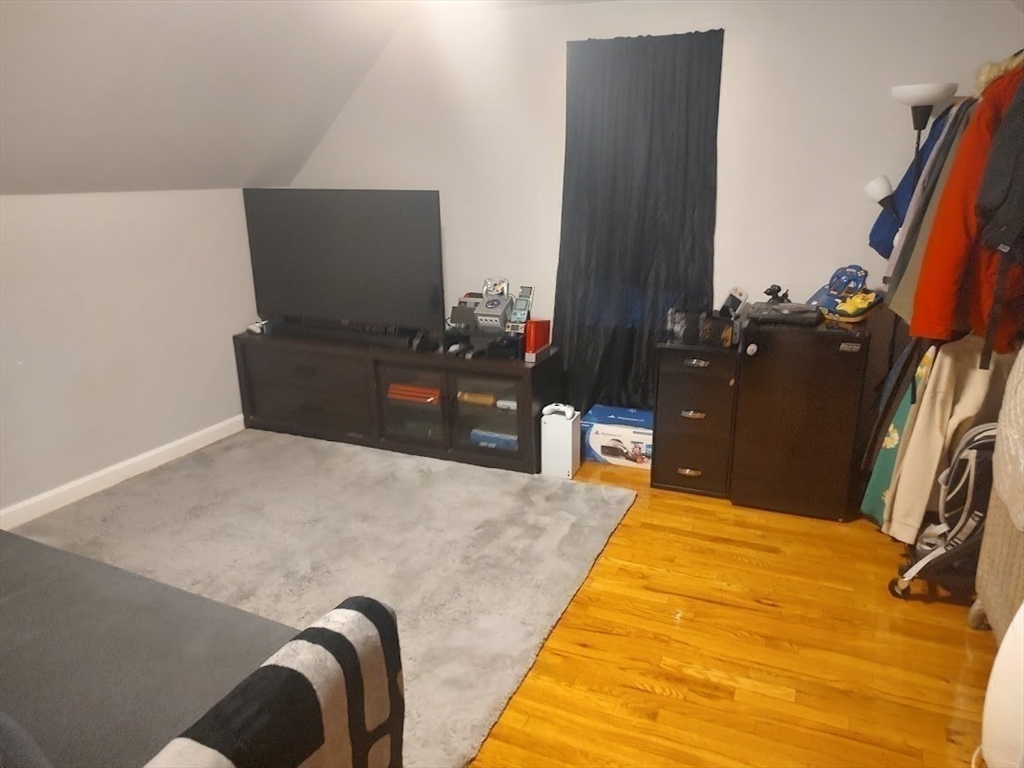 378 Ferry Street Everett, MA 02149 - Photo 18 of 26 a bedroom with a bed and a flat screen tv