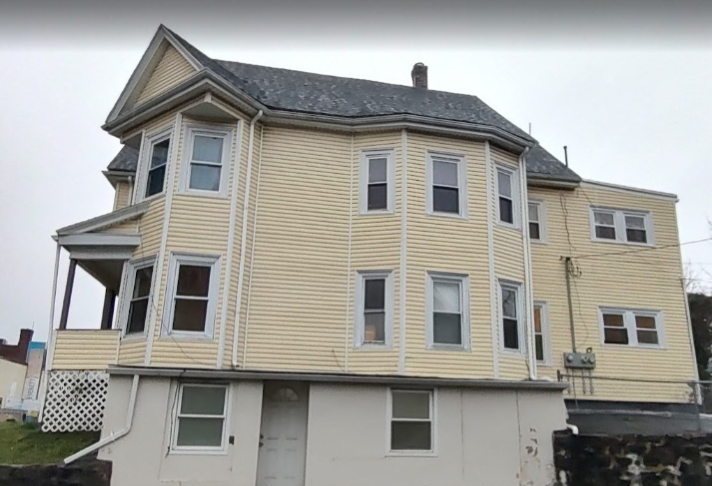 378 Ferry Street Everett, MA 02149 - Photo 2 of 26 a front view of a house with a balcony