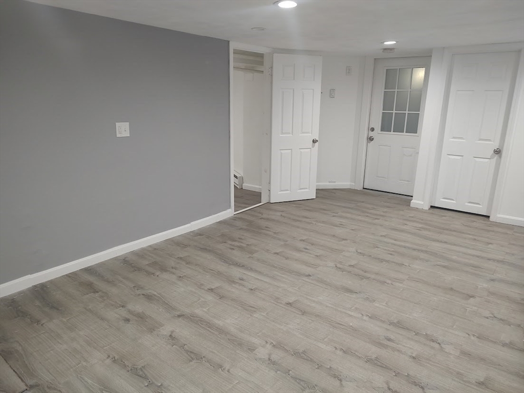 378 Ferry Street Everett, MA 02149 - Photo 22 of 26 a view of an empty room with wooden floor