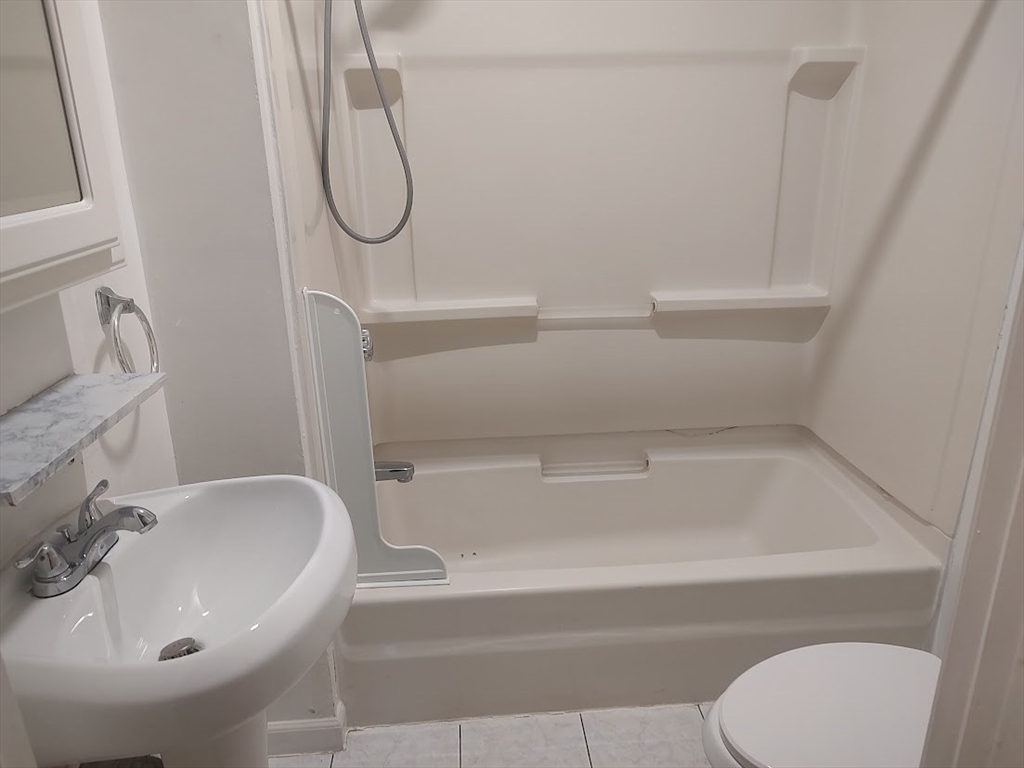 378 Ferry Street Everett, MA 02149 - Photo 8 of 26 a bathroom with a sink and a mirror