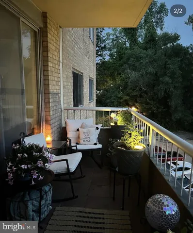 a balcony with wooden floor and outdoor seating