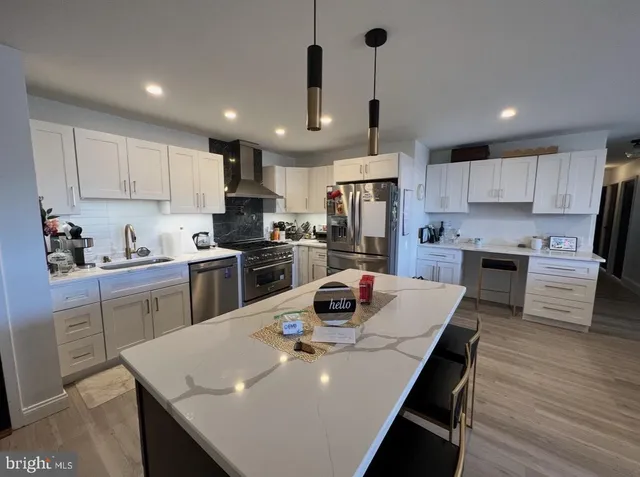 a kitchen with refrigerator cabinets dining table and chairs
