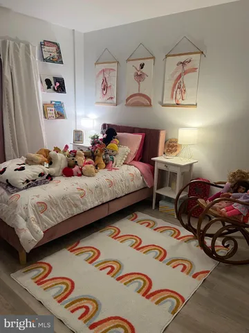 a bedroom with bed and cupboard