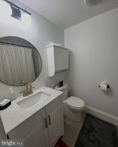 a bathroom with a sink toilet and mirror