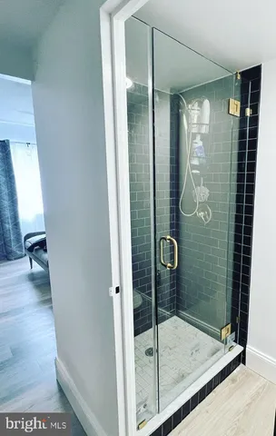 a bathroom with a glass shower door