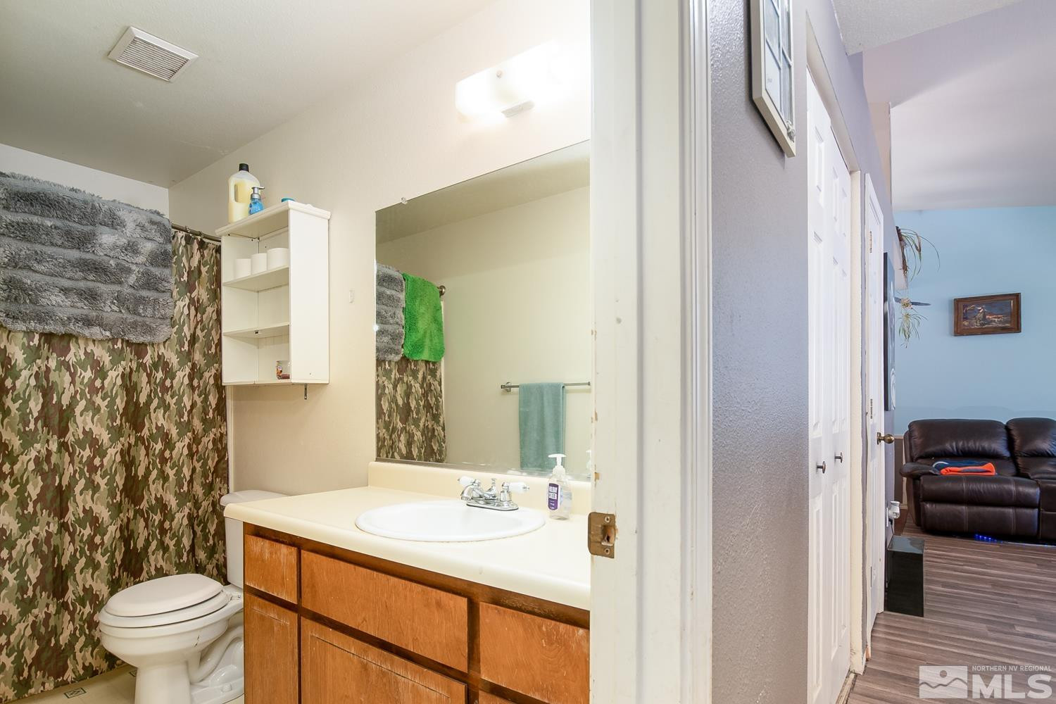 574 Yellow Jacket Road Dayton, NV 89403 - Photo 13 of 37 a bathroom with a sink and a mirror