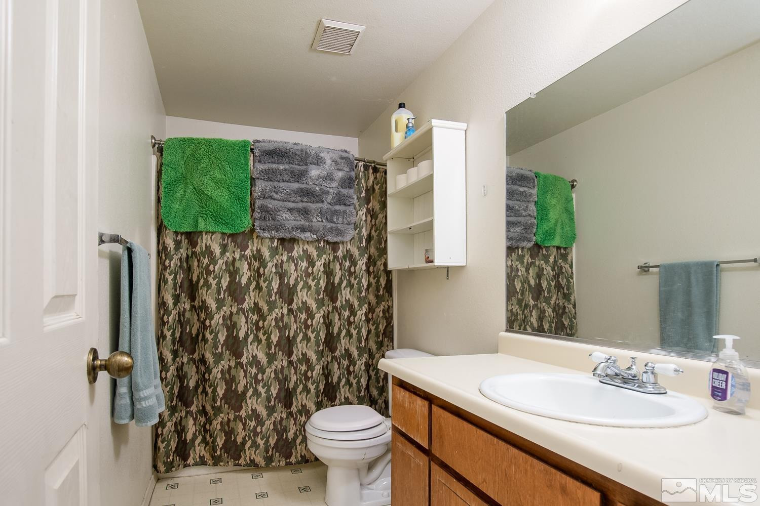 574 Yellow Jacket Road Dayton, NV 89403 - Photo 14 of 37 a bathroom with a sink toilet and shower