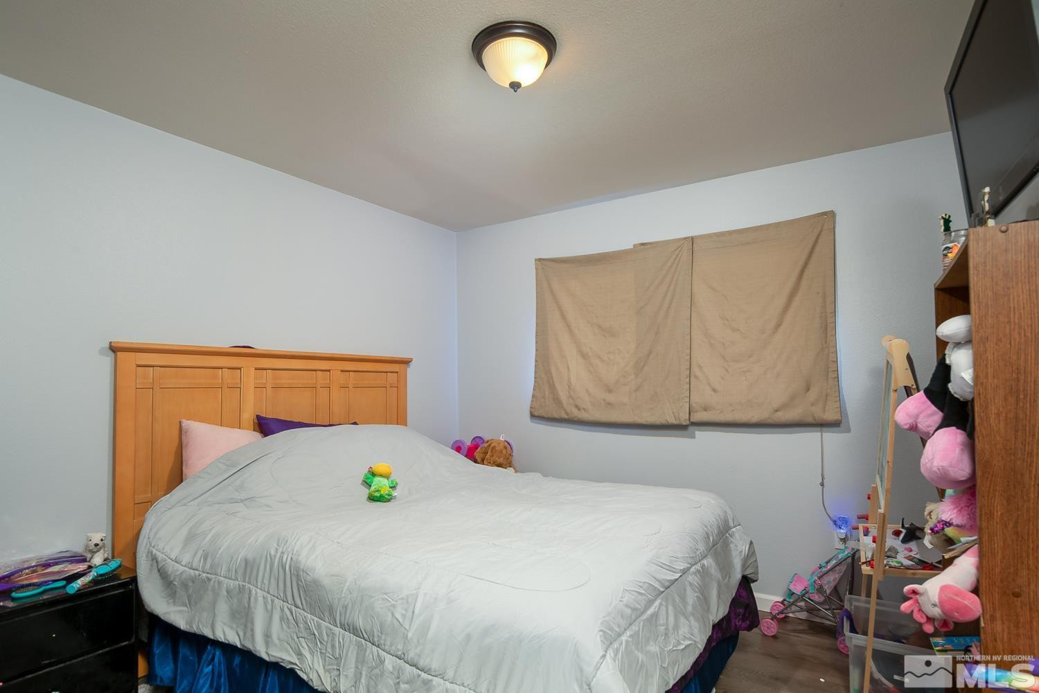 574 Yellow Jacket Road Dayton, NV 89403 - Photo 15 of 37 a bedroom with a bed and a window