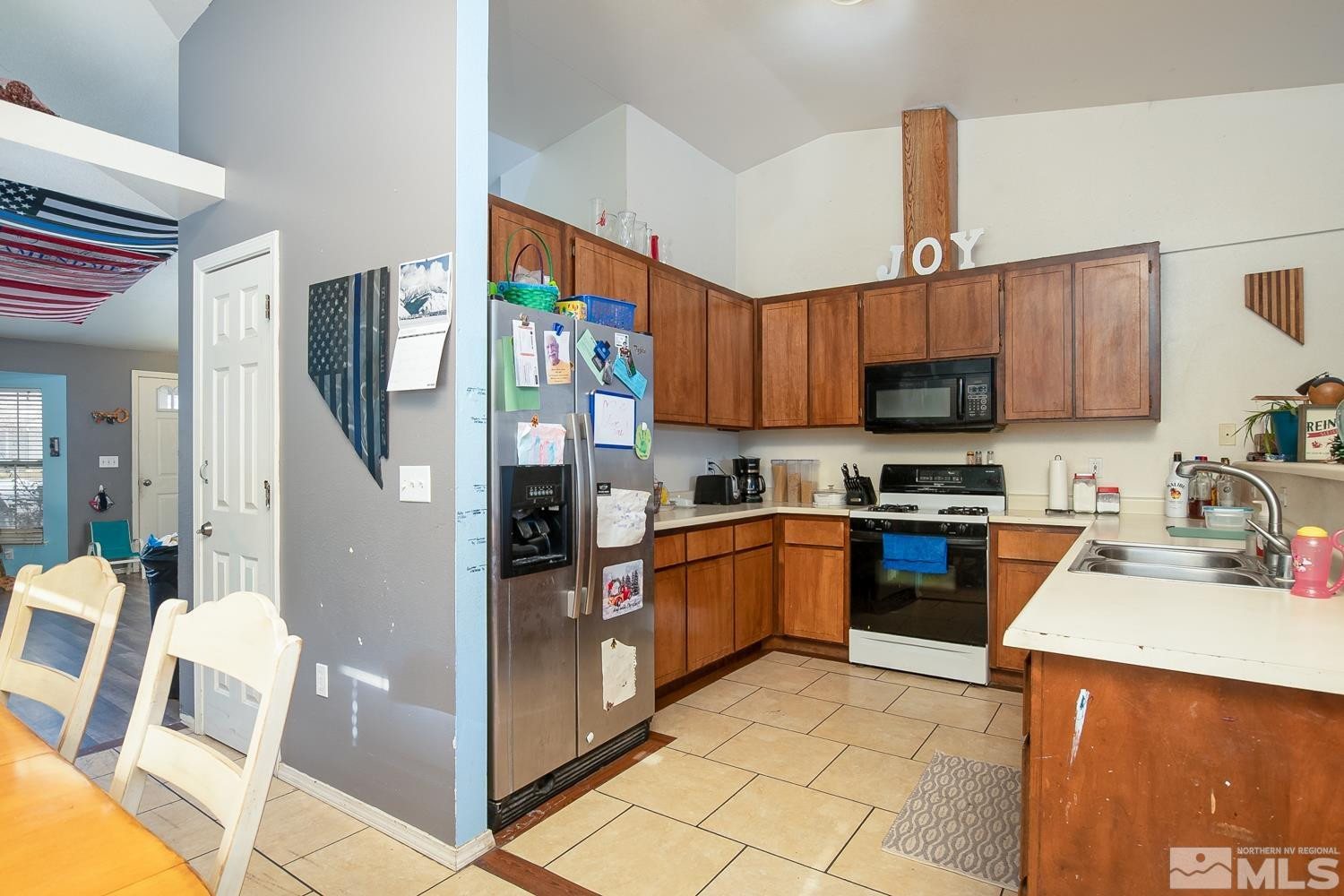574 Yellow Jacket Road Dayton, NV 89403 - Photo 8 of 37 a kitchen with stainless steel appliances granite countertop a refrigerator and a stove top oven