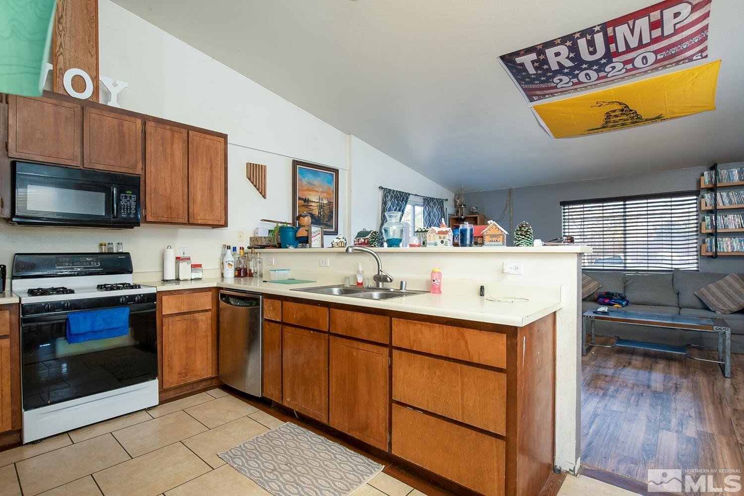 574 Yellow Jacket Road Dayton, NV 89403 - Photo 9 of 37 a kitchen with a sink and wooden cabinets