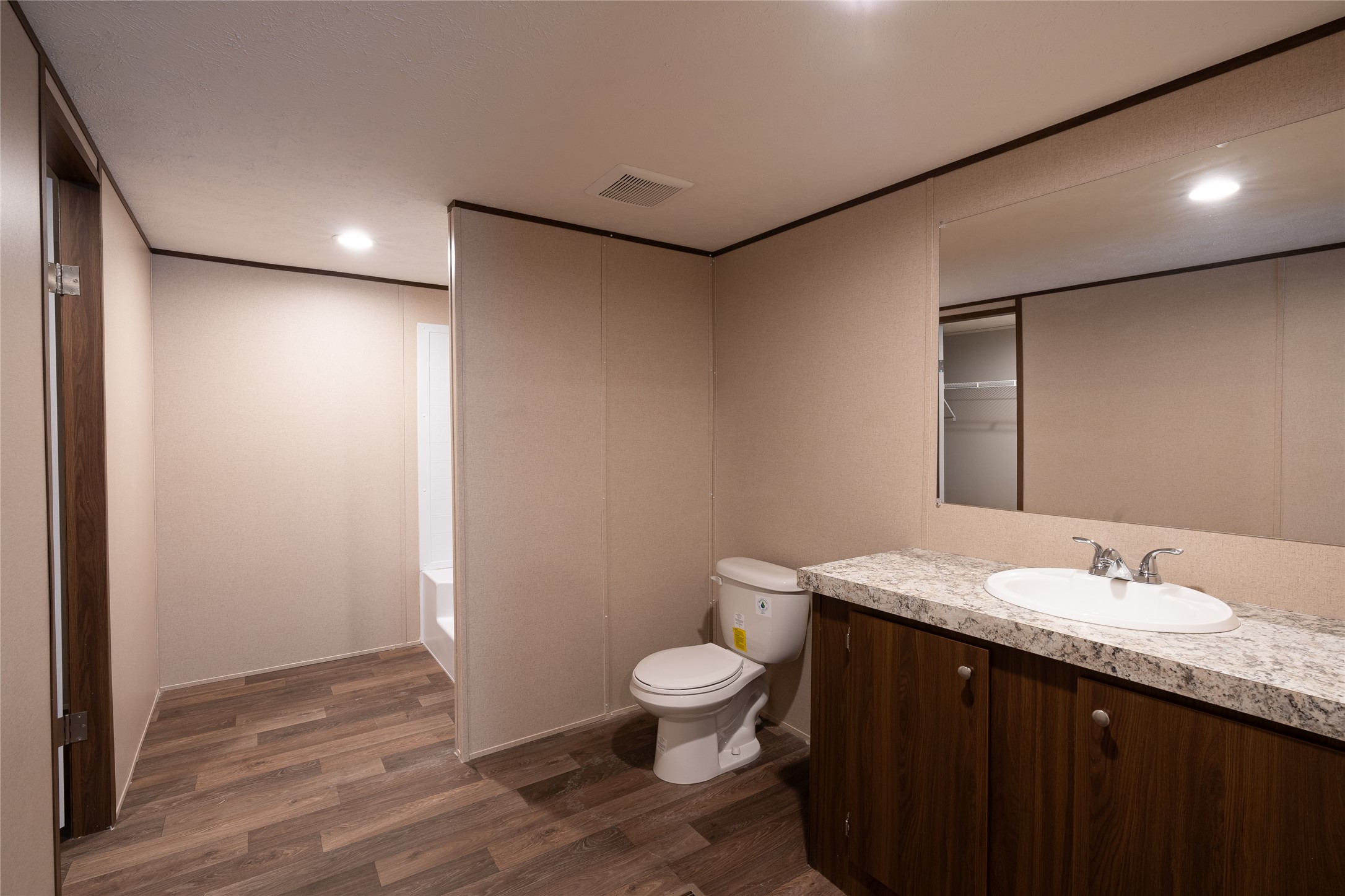 6945 Seawillow Road Lockhart, TX 78644 - Photo 15 of 21 a bathroom with a granite countertop sink a toilet and a mirror