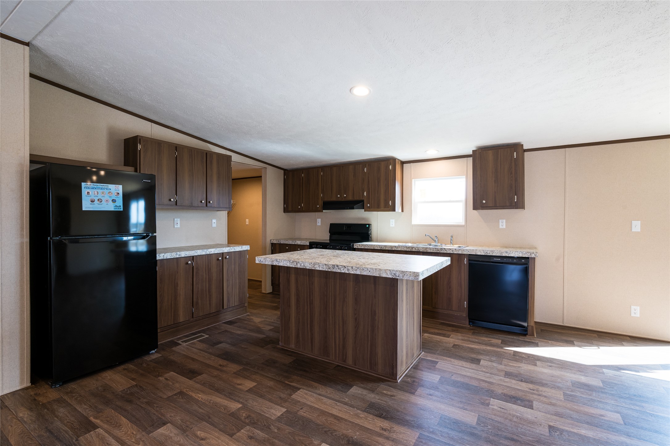 6945 Seawillow Road Lockhart, TX 78644 - Photo 6 of 21 a kitchen with a sink a counter top space and stainless steel appliances
