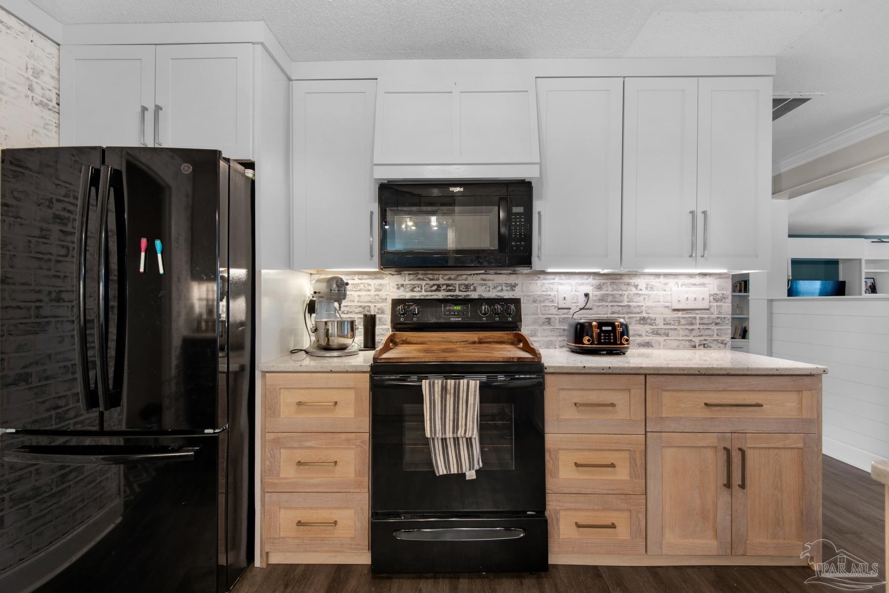 4316 Highland Boulevard Pace, FL 32571 - Photo 17 of 43 a kitchen with cabinets appliances and a counter space