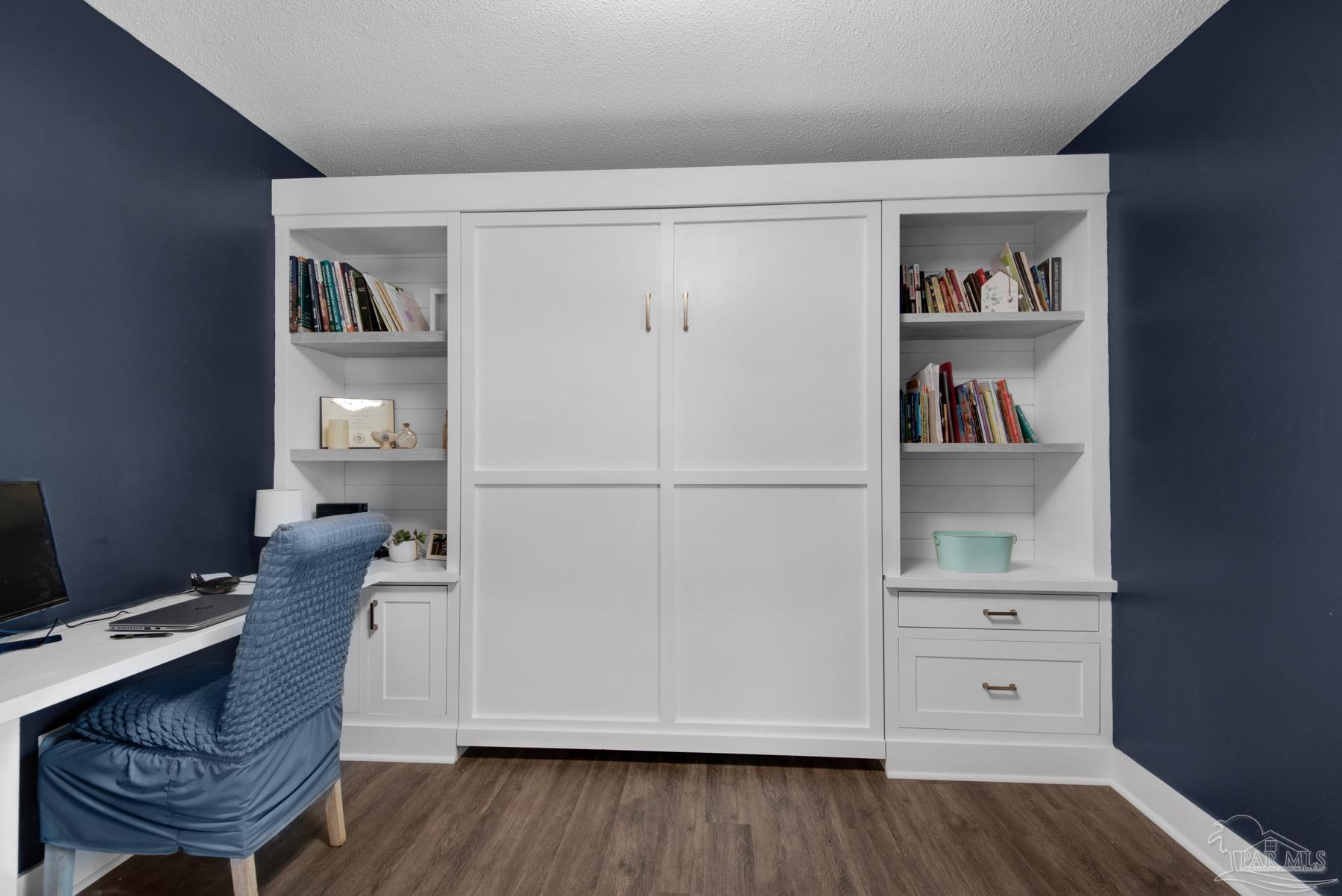 4316 Highland Boulevard Pace, FL 32571 - Photo 27 of 43 a workspace with furniture and wooden floor