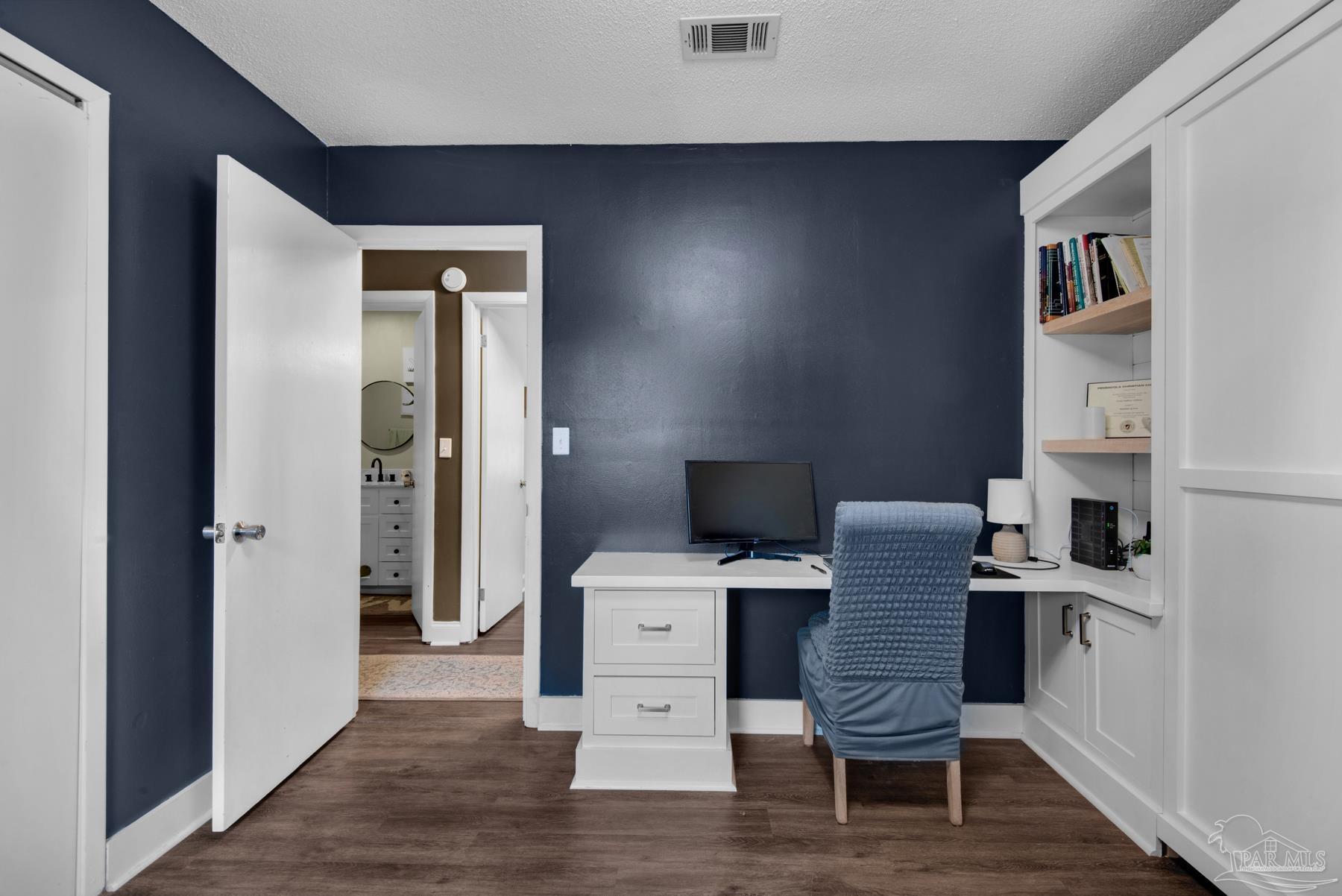 4316 Highland Boulevard Pace, FL 32571 - Photo 28 of 43 a workspace with furniture and wooden floor