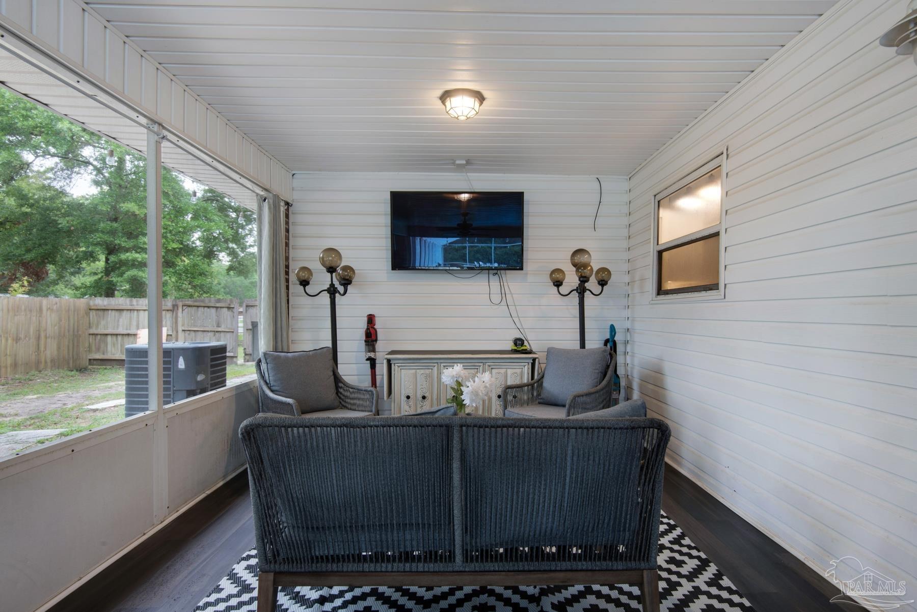 4316 Highland Boulevard Pace, FL 32571 - Photo 32 of 43 a living room with furniture and a flat screen tv