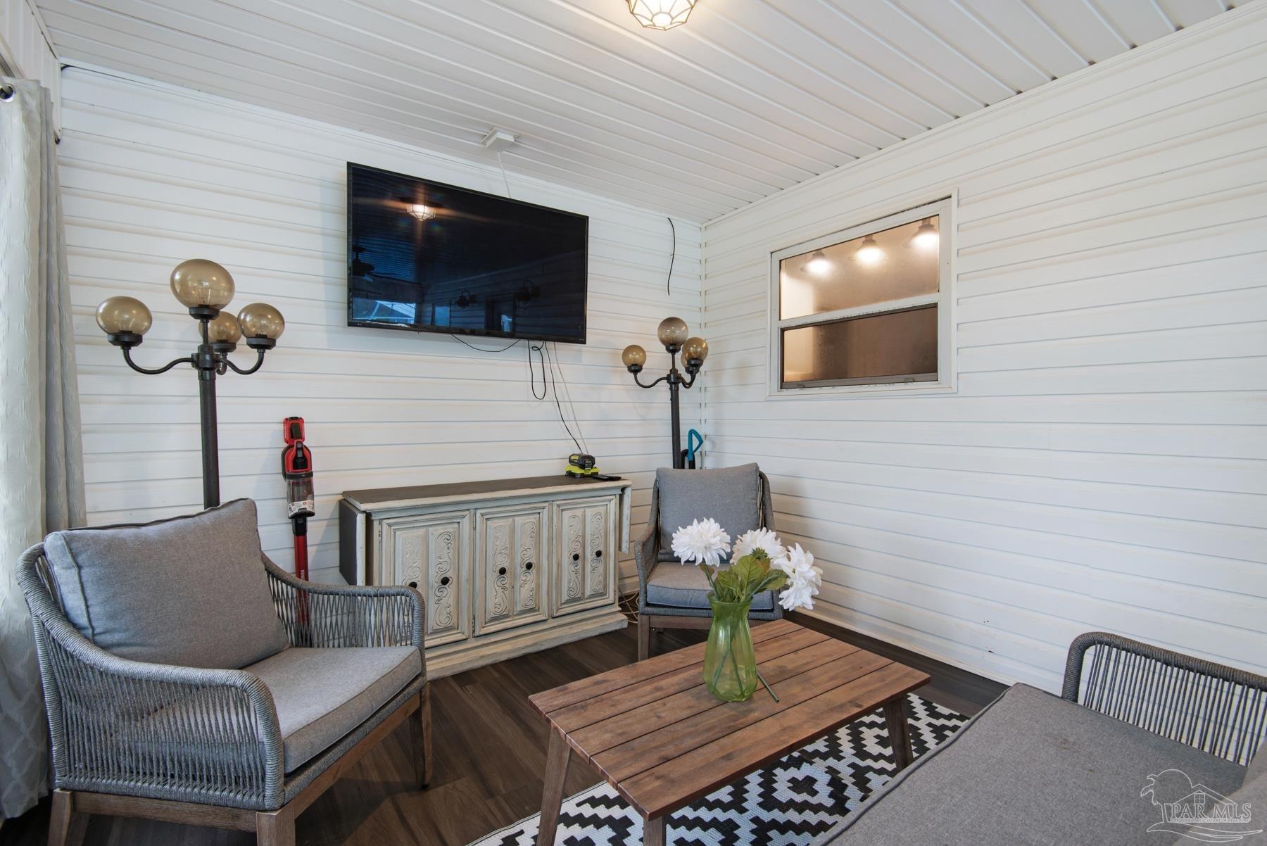 4316 Highland Boulevard Pace, FL 32571 - Photo 33 of 43 a living room with furniture and a flat screen tv