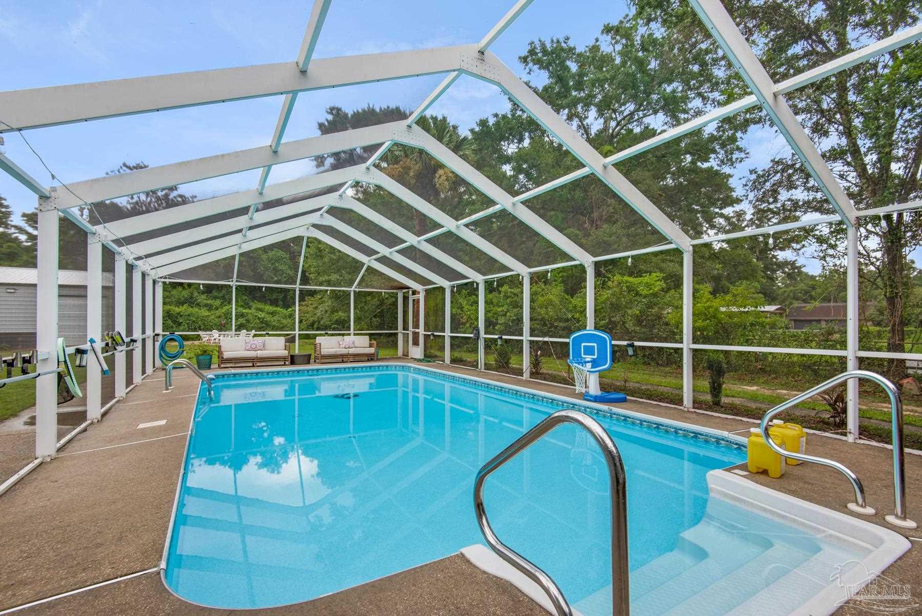 4316 Highland Boulevard Pace, FL 32571 - Photo 37 of 43 a view of a swimming pool with a patio