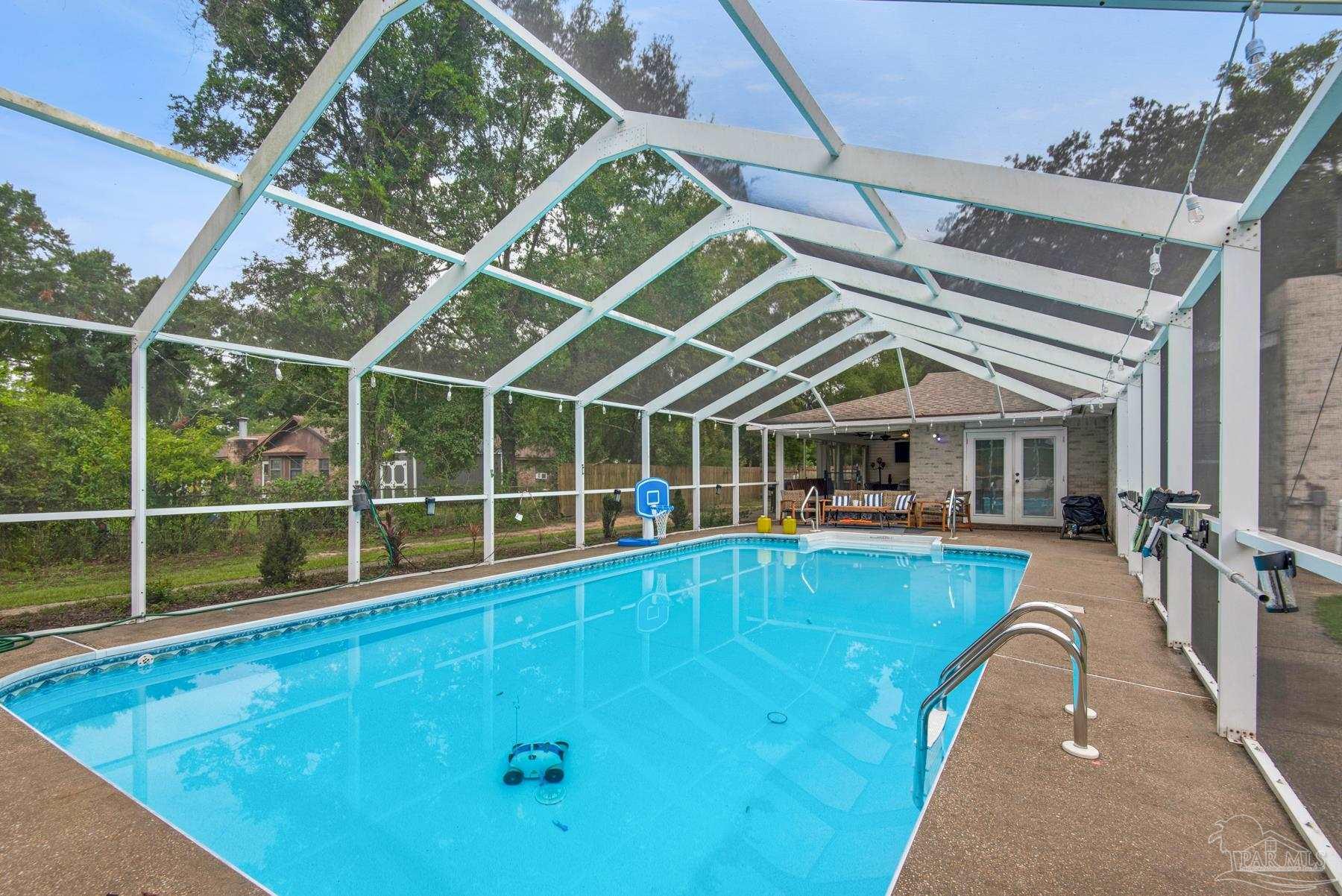 4316 Highland Boulevard Pace, FL 32571 - Photo 38 of 43 a view of a house with a swimming pool