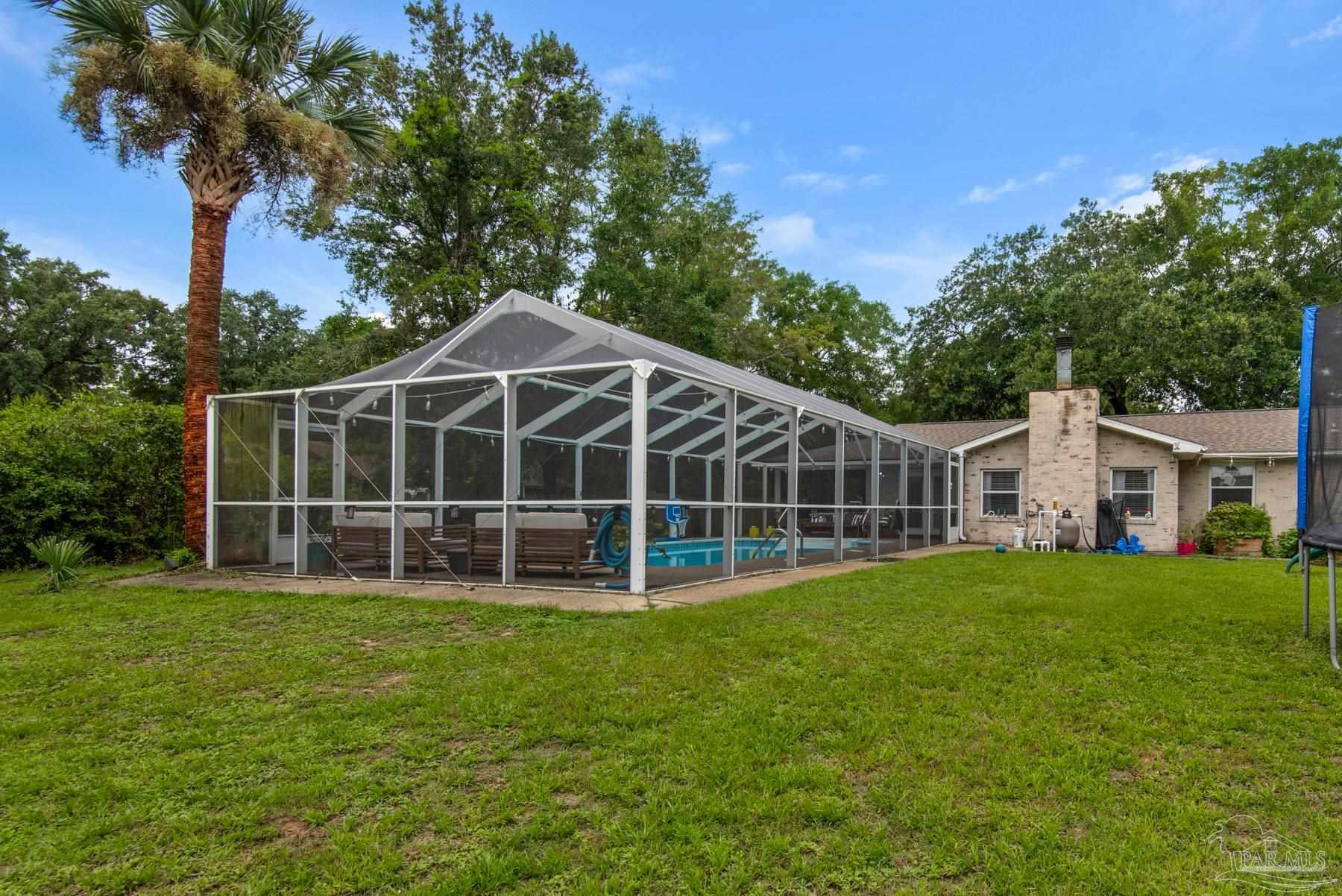 4316 Highland Boulevard Pace, FL 32571 - Photo 39 of 43 a view of a house with a yard