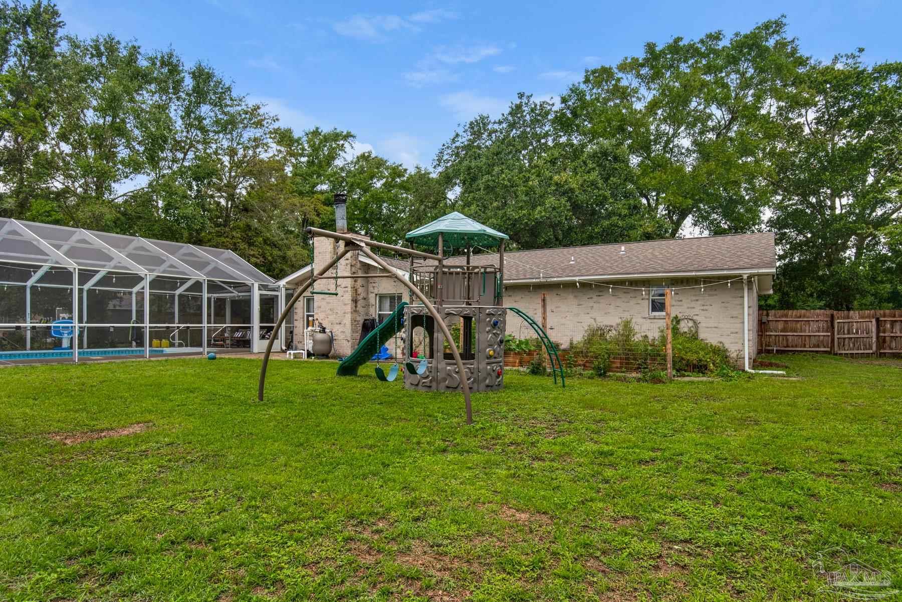 4316 Highland Boulevard Pace, FL 32571 - Photo 43 of 43 a view of a house with a yard and sitting area