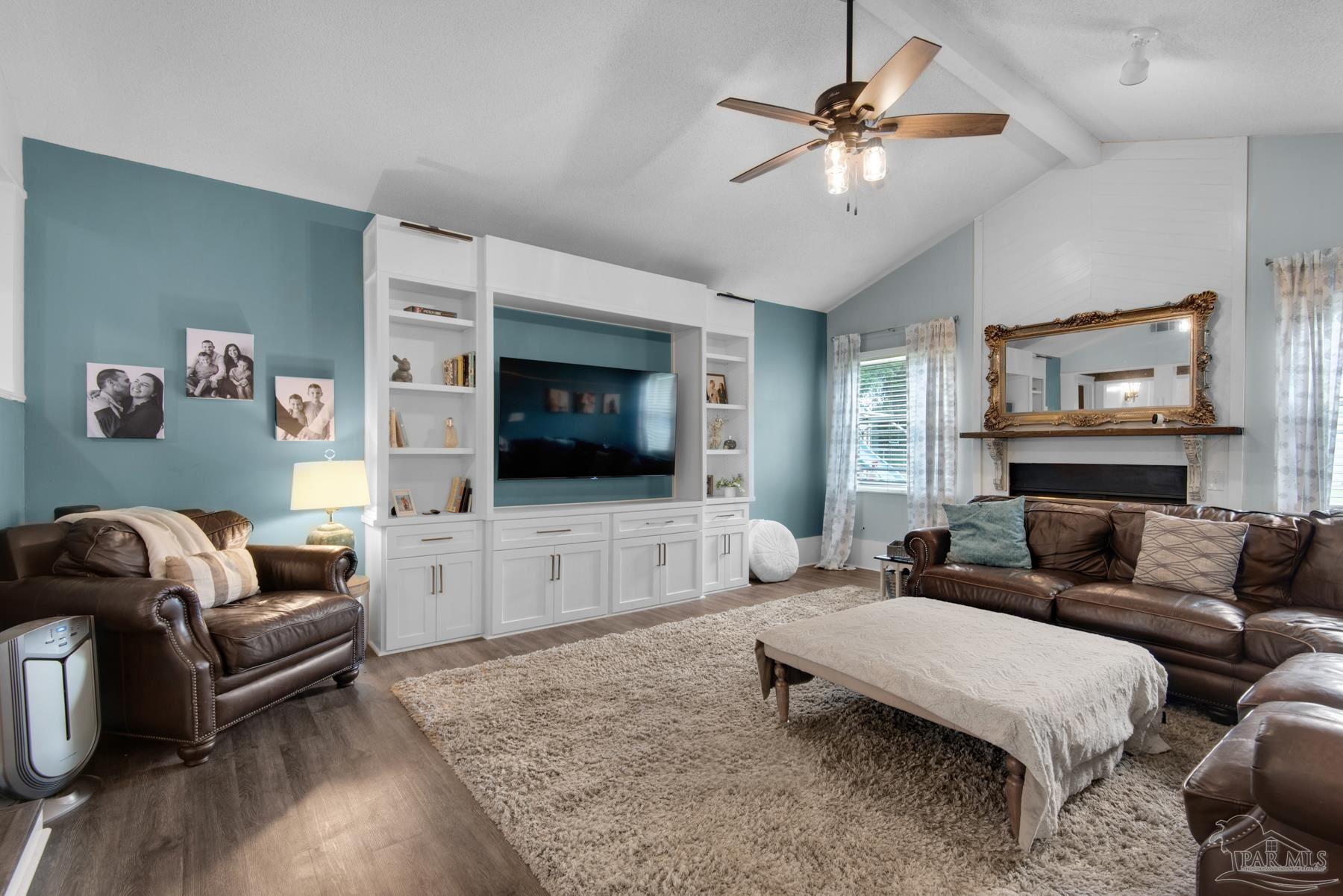 4316 Highland Boulevard Pace, FL 32571 - Photo 10 of 43 a living room with furniture and a flat screen tv