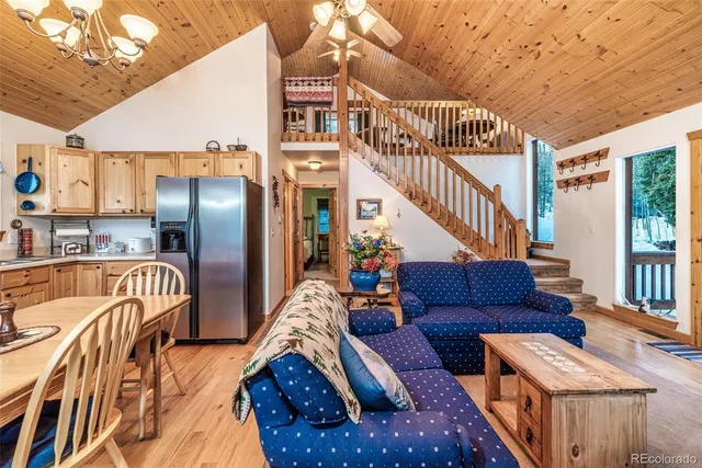 a view of a livingroom with furniture and stairs