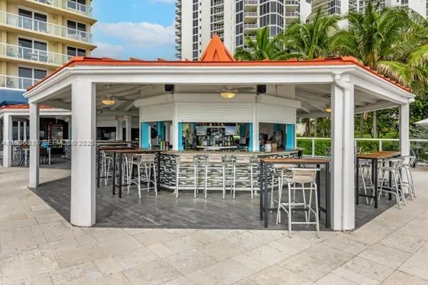 a living room with furniture and a large mirror