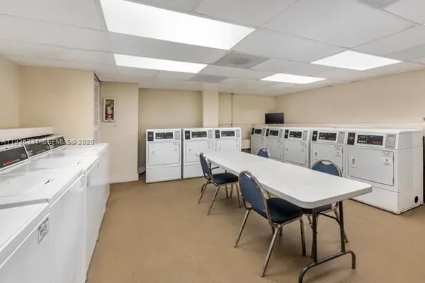 a large room with lots of white furniture