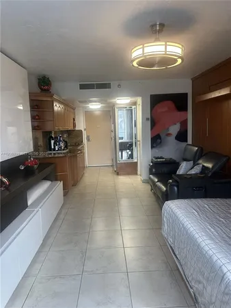 a bathroom with a granite countertop toilet sink and mirror